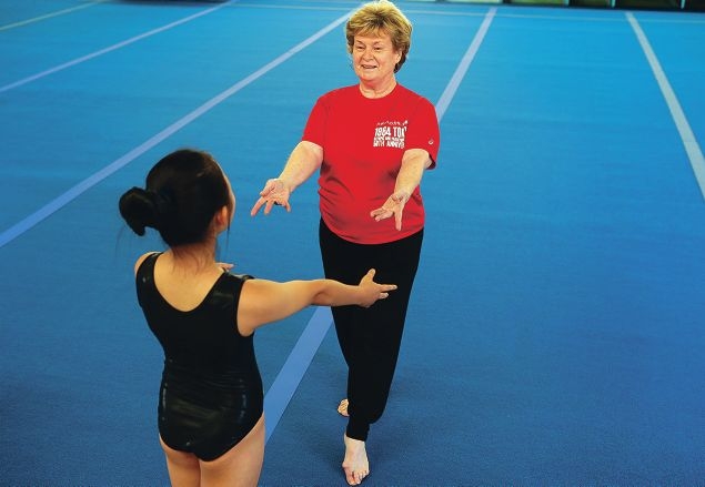 Val Norris-Buffham works with gymnast Erina Hong.