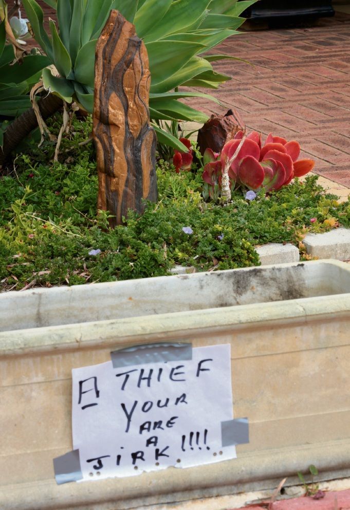 The sign left on the pot plant. Picture: David Baylis.