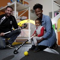 Vice President Fremantle Hockey Club Matt Allen with Oumou Bah and her daughter Samara Chentelat (2.5 y old) having a play with the hockey gear. Picture: Marie Nirme