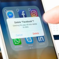Antibes, France - February 22, 2018: User deletes Facebook app from iPhone. The social media platform faces increased scrutiny around personal data privacy and its handing of fake news and extremist content.