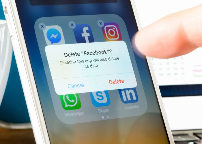 Antibes, France - February 22, 2018: User deletes Facebook app from iPhone. The social media platform faces increased scrutiny around personal data privacy and its handing of fake news and extremist content.