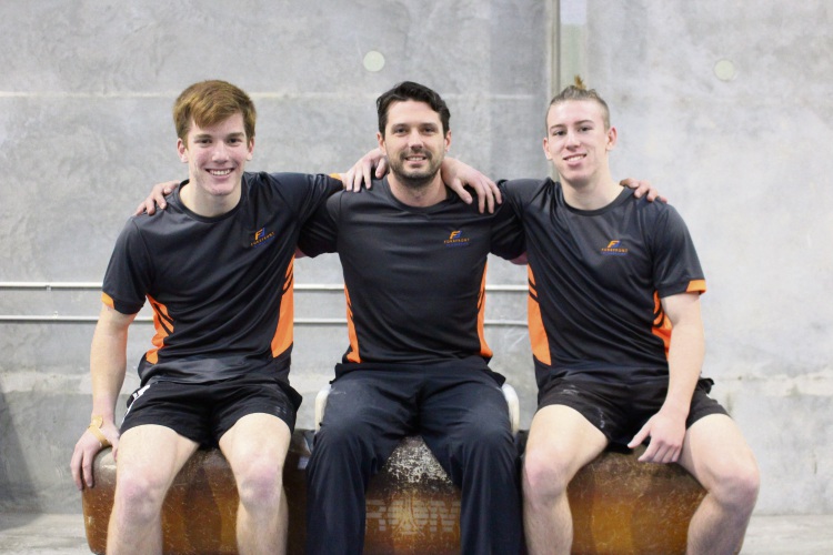 Australian Gymnastics Championship medallists Joel Humich (left) and Josiah Hunter with their coach Darren Hicks (middle).