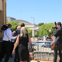 A Joondalup Magistrates Court security guard tries to move on supporters of kangaroo torturer Dylan Griffin. Picture: Anton La Macchia