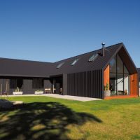 The metal sheeting used on the roof was bent down to form the walls in this Scandinavian-inspired Albany home.