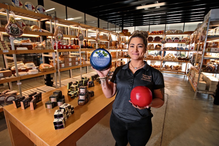 Rae Rhodes with Wensleydale and Blueberry cheese from Somerdale and Edam Cheese Ball from Frico inside the refrigerated cheese room. Photo: David Baylis