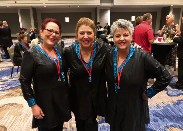 Helen Bolton, Lions Gate Chorus director Sandy Marron and Kali Caramia.