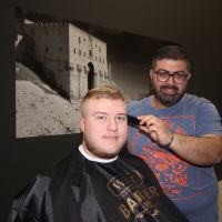Eddy Baladi cuts Cameron Boelema’s hair at his Aleppo Klippers barber shop in Joondalup.