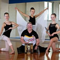 Calisthenics students Chloe Haliburton (13), Ellashaye Adamos (8) and Kimberley Adamos (12) with coach Christine Polglaze with some of her recent awards including the Ian Halliday Outstanding Service Award to Calisthenics in WA. Picture: David Baylis d497697