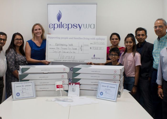Epilepsy WA chief executive Emma Buitendag (centre) accepts the donation from the organisers of Joondalup's Hindu Navrang Festival and members of the band Sweet Melodies. Picture: Shannon Wharton