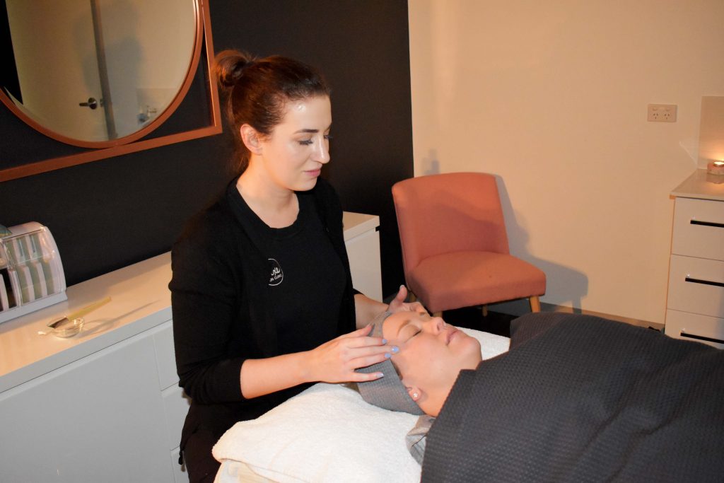 Senior Skin Therapist Joanna Lay gives her client a temple massage at the beginning of her treatment.