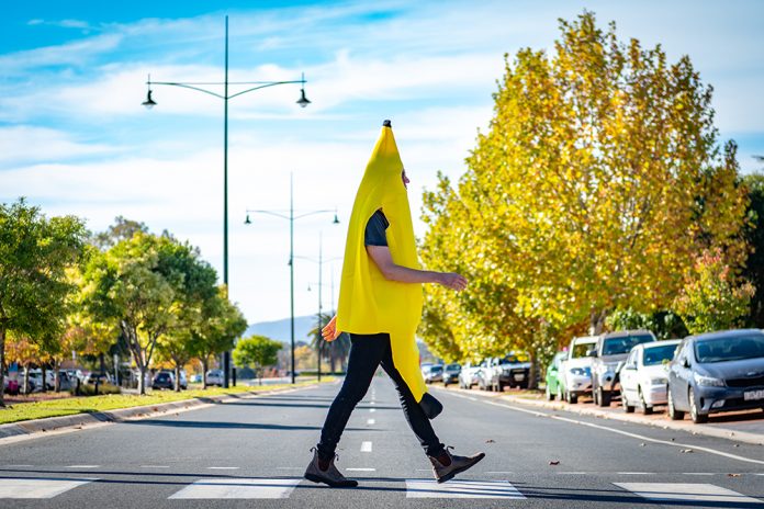 Kyle walking across pedestrian crossing