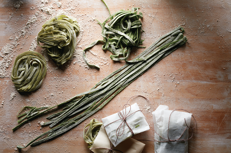 Green pasta on a bench made by the Total Nutrition Centre blender.