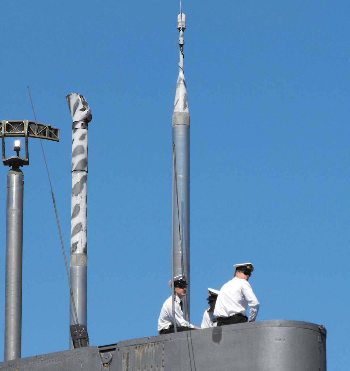 Navy piolt and assistants on the submaine