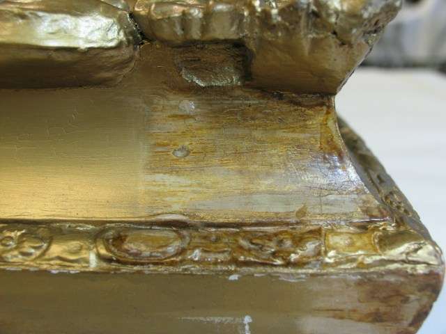 detail shot of the corner of the frame.left side is bronze paint .right side is cleaned area