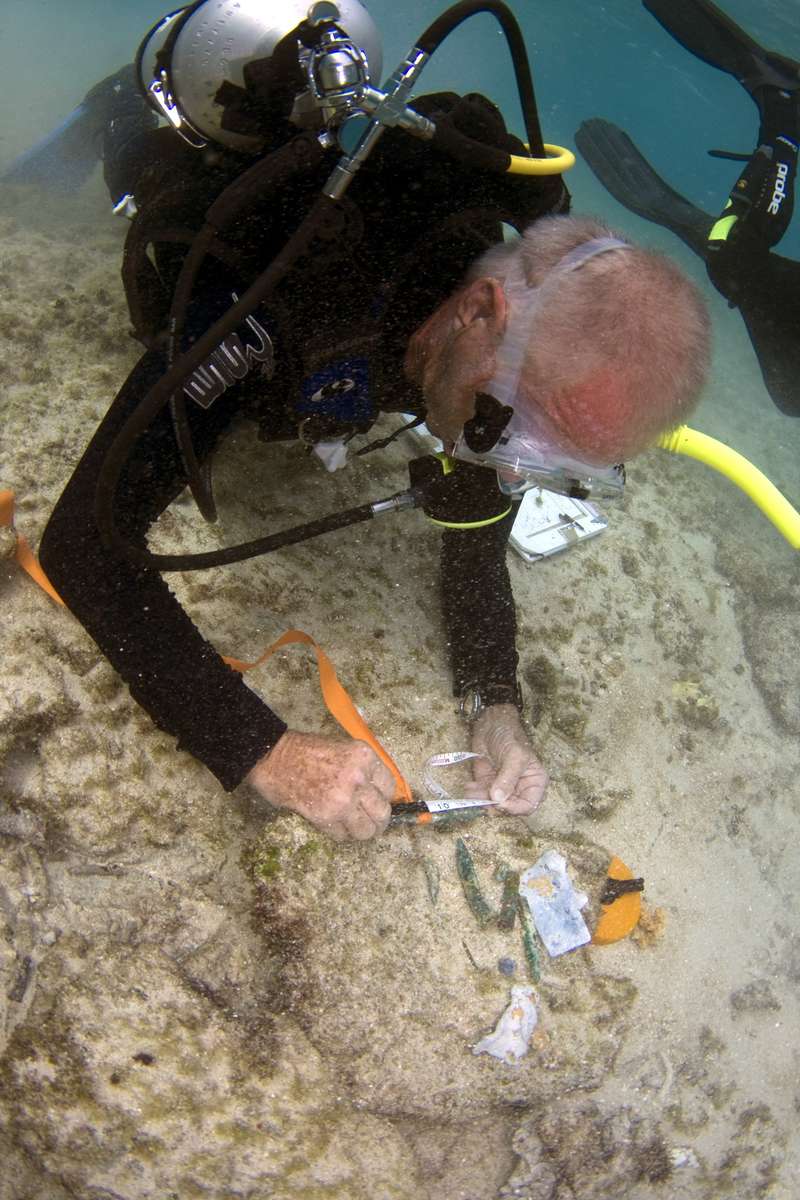 An expedition diver recording a scatter of ship