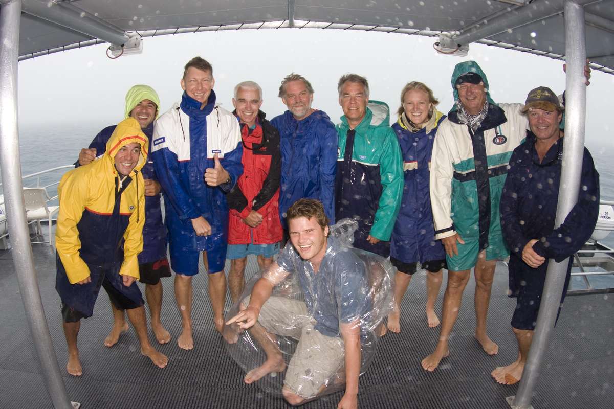 Members of the Mermaid Project during a rain squall.