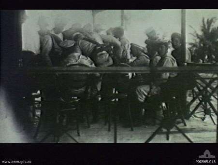 Crew From the HMAS Sydney celebrating on the Cocos Islands. Australian War Memorial P00565.018.