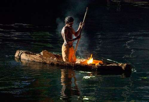 Bark canoe on water at Nawi opening ceremony.