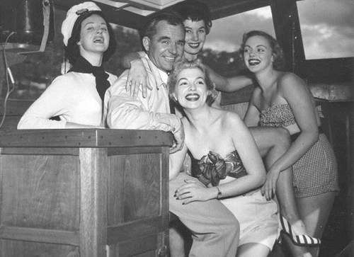 Archive photo of Carl Halvorsen with goup of glamorous ladies on board a luxury cruiser