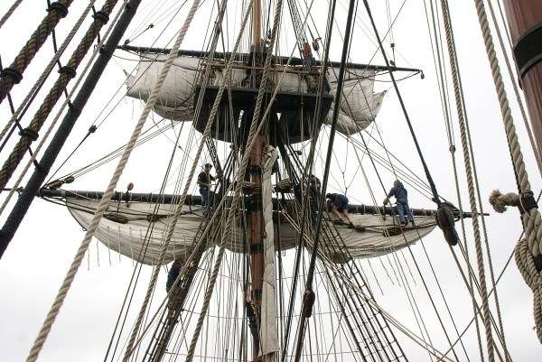 Photograph of Endeavour crew working on the sails