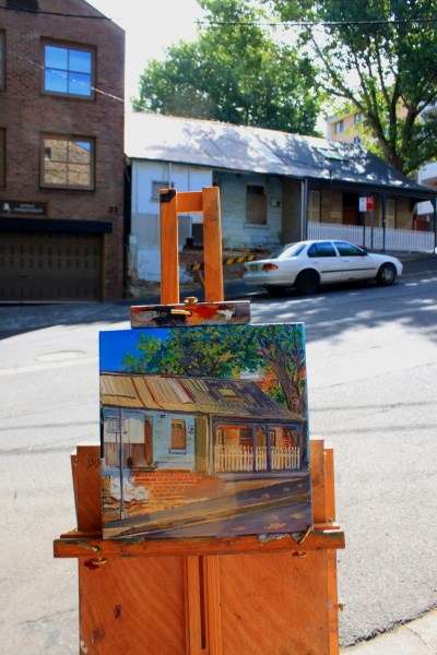 Photo of painting easel in front of two cottages on Pyrmont Street