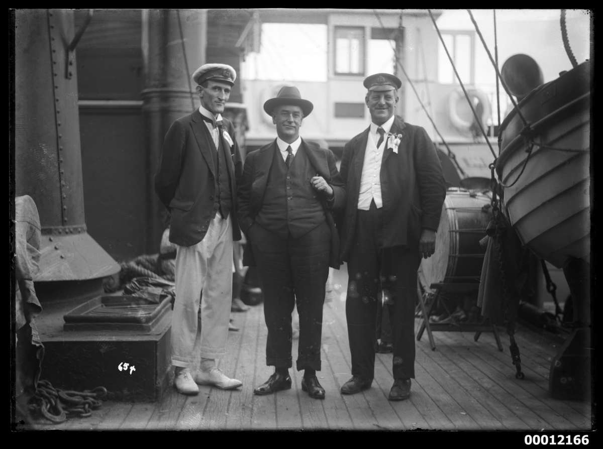 Mr John Roche (left), Mr F. J. S. Young (right) and an unidentified man onboard NAMOI, at the Pittwater Regatta. ANMM Collection 00012166