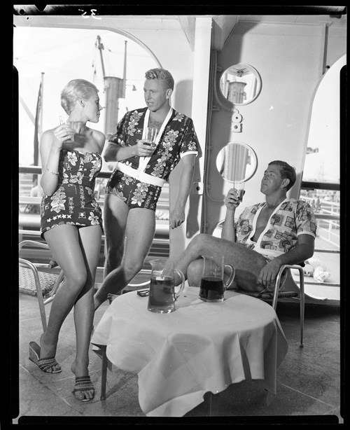 Photo of two men and one woman at table on cruise liner