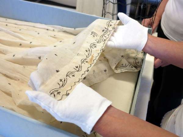 Women holding dress with brown stain on hem