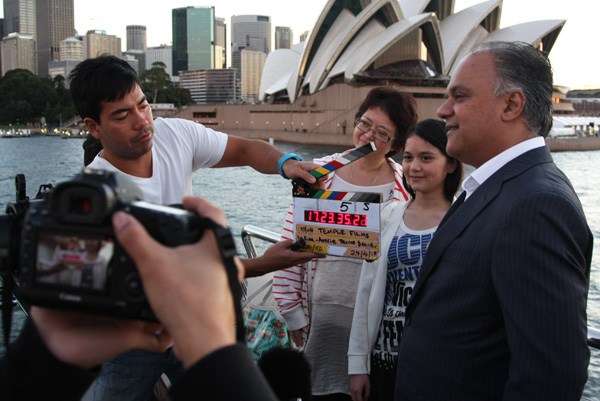 Indian Aussie Cruise Owner Sudhir Warrior with Japanese Aussie Indian family talking to film crew.