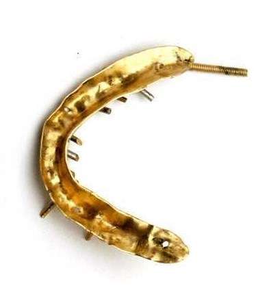 Another denture from the Dunbar showing the teeth attachment screws and a single spring at the side.  ANMM Collection