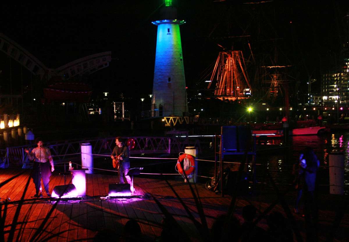 Evie J Performing with the iconic backdrop Museums Lighthouse...