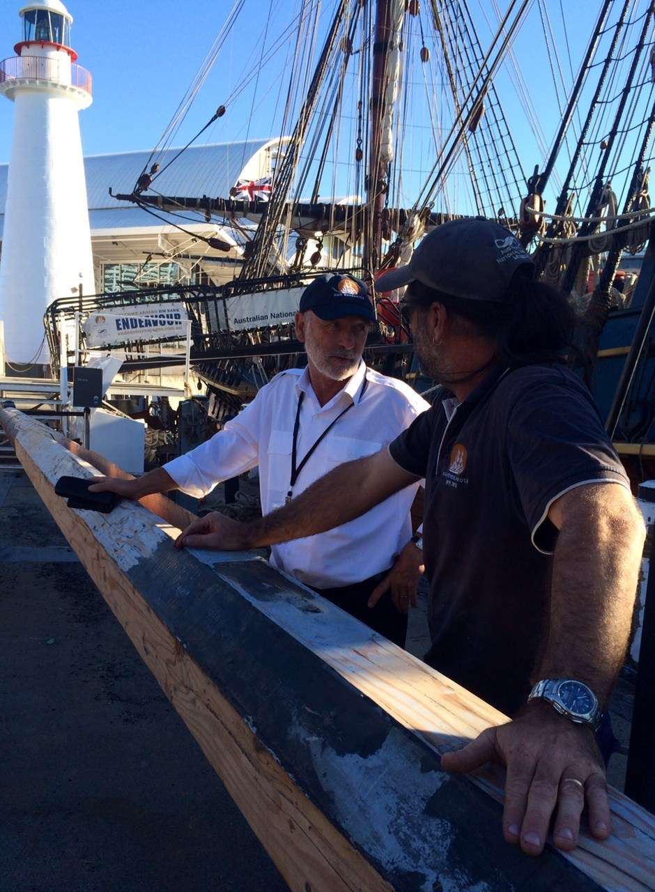 Discussing the upcoming voyages while making repairs to the main yard.