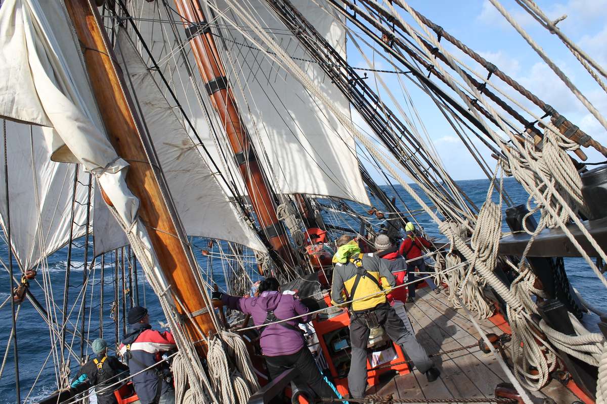 Voyage crew at the helm of HMB Endeavour. Photo by Suzannah Marshall Macbeth.