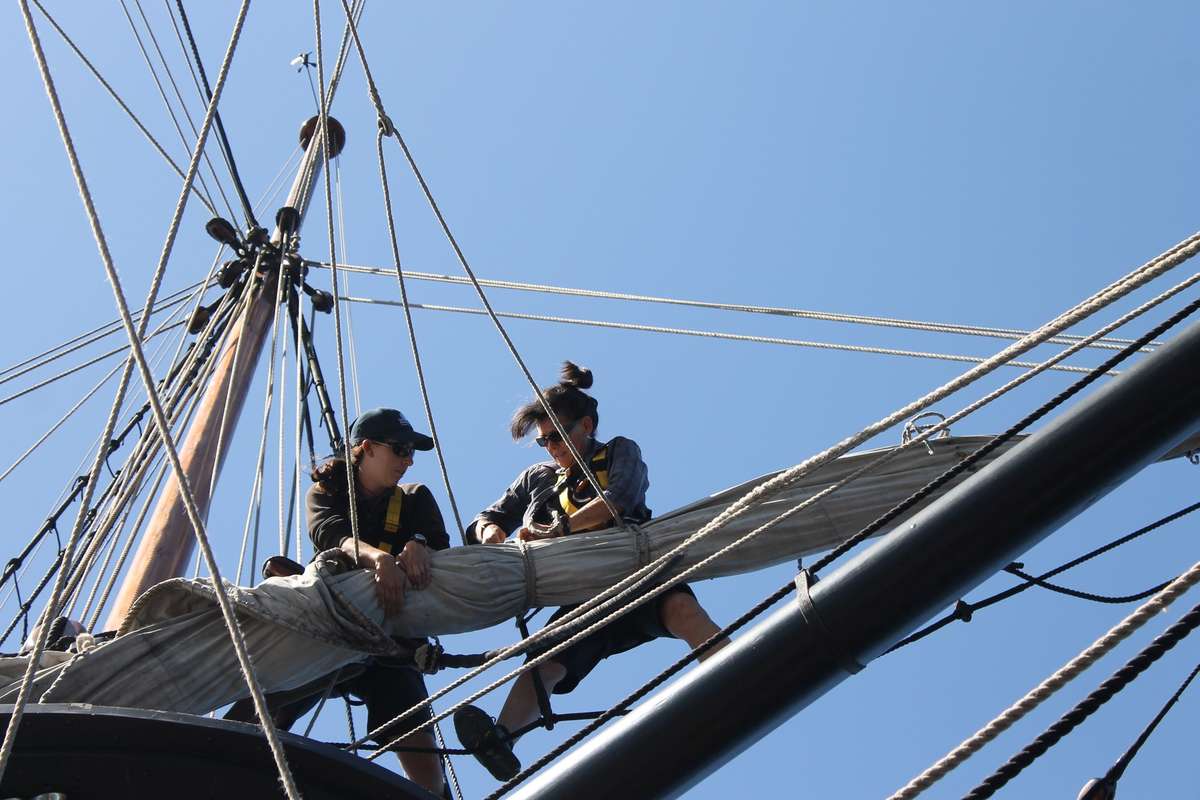 Crew working aloft preparing to set sail. Image EAP