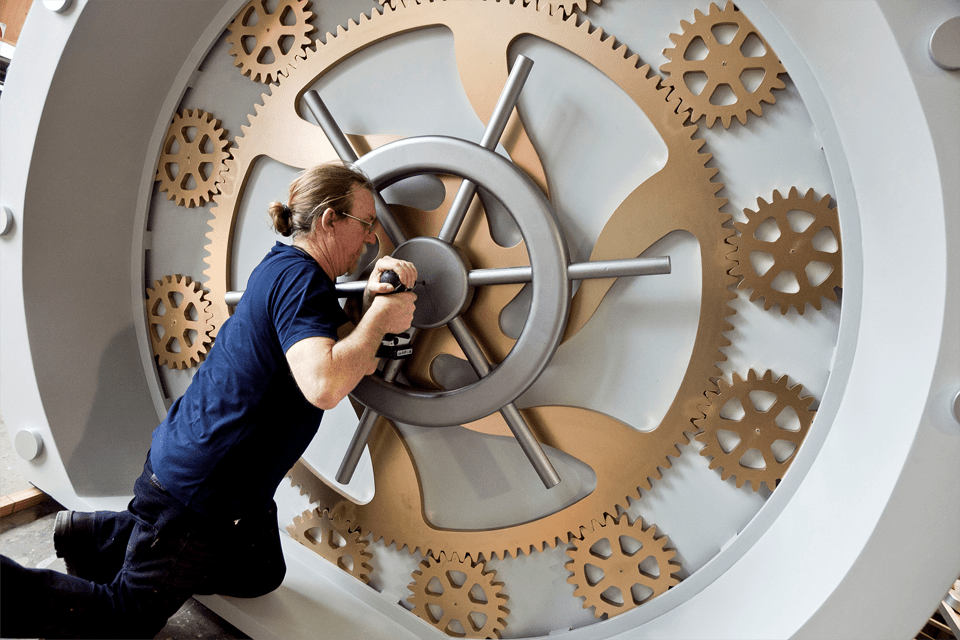 Preparator Peter Buckely with the airlock-style door that forms the entry to the exhibition Voyage to the Deep