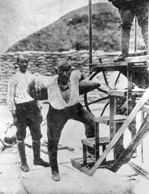 A Turkish artilleryman lifts a 258 kilogram shell singlehanded for loading in a cannon. Corporal Seyit (Seyit Onbasi) is famous for having carried three 275 kg shells to an artillery gun during the Allied attempt to force the Dardanelles on 18 March 1915. Born in a the village of Havran, he enlisted into the army in April 1909. After serving in the Balkan Wars of 1912-1913 he was transferred to the forts defending the Mediterranean entrance to the Dardanelles. Following the heavy naval bombardment of the forts guarding the Narrows on 18 March 1915, the gun he was serving in the Mecidiye fort remained operational but its shell crane had been damaged. Seyit carried three 275 kg artillery shells up to the gun enabling it to continue firing on the attacking Allied fleet. One of the shells reputedly hit the British pre-dreadnought HMS Ocean, although the ship was sunk by a mine laid by the minelayer Nusret. Following the repulse of the naval assault, Seyid was promoted to corporal and publicised as an iconic Turkish hero. He was discharged in 1918 and became a forester and later coal-miner. He took the surname Çabuk in 1934 with the passing of the Surname Law. He died of a lung disease in 1939. A statue of him carrying a shell was erected in 1992, just south of Kilitbahir Castle on the Gallipoli Peninsula.