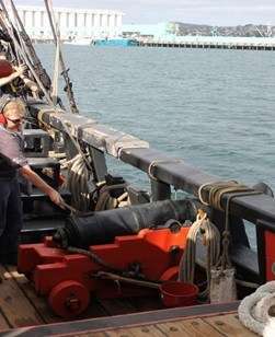 Putting the slow match to the touch hole. Image: ANMM.