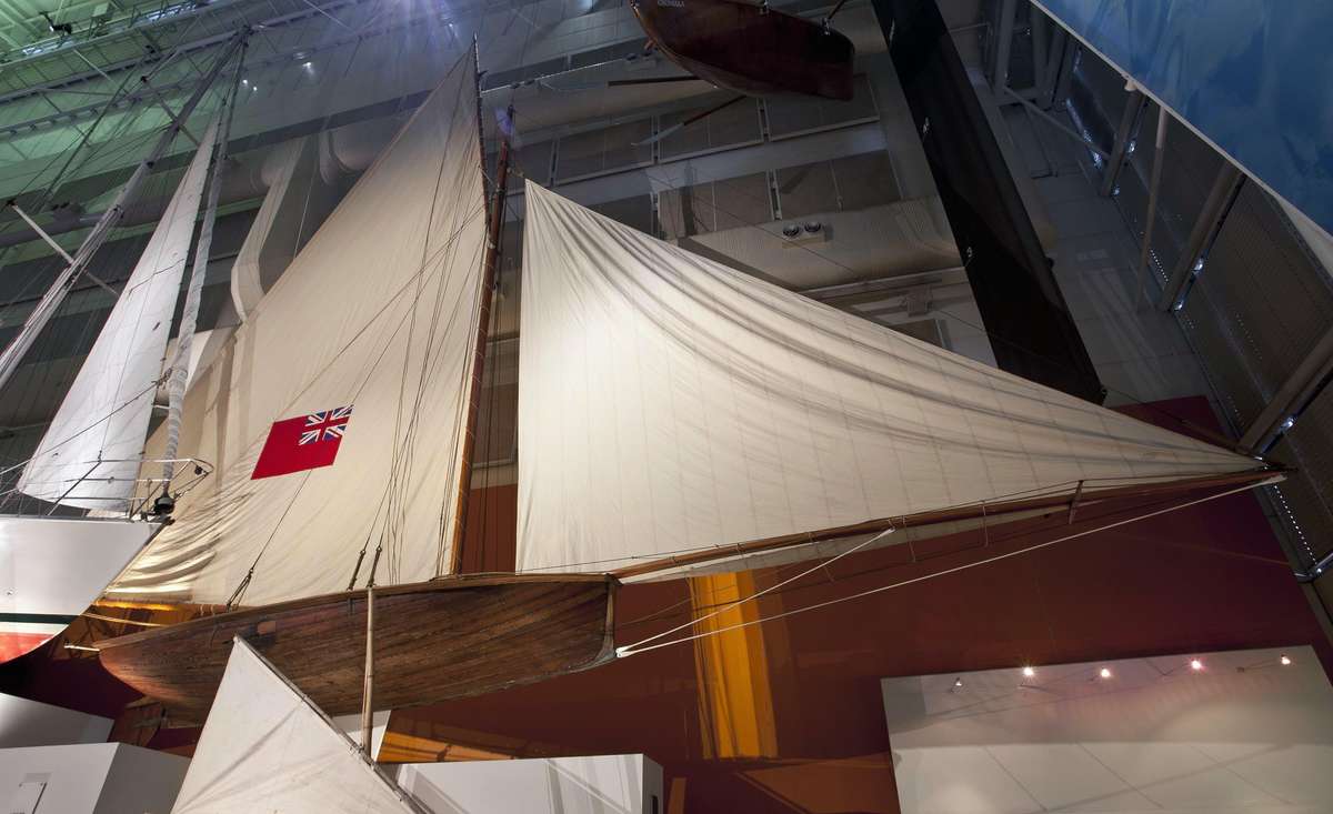 18 foot racing skiff BRITANNIA suspended from the 34 meter high Watermarks gallery . ANMM collection 00000082.