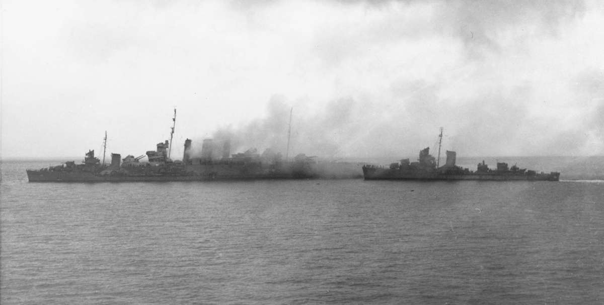 USS Blue on HMAS <em>Canberra’s</em> port bow and USS <em>Patterson</em> approaching to rescue survivors on 9th August 1942. Image: US Naval History and Heritage Command.