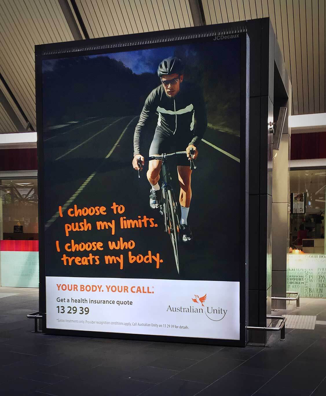 Australian Unity | Man cycling along dark road | Out of home advertising
