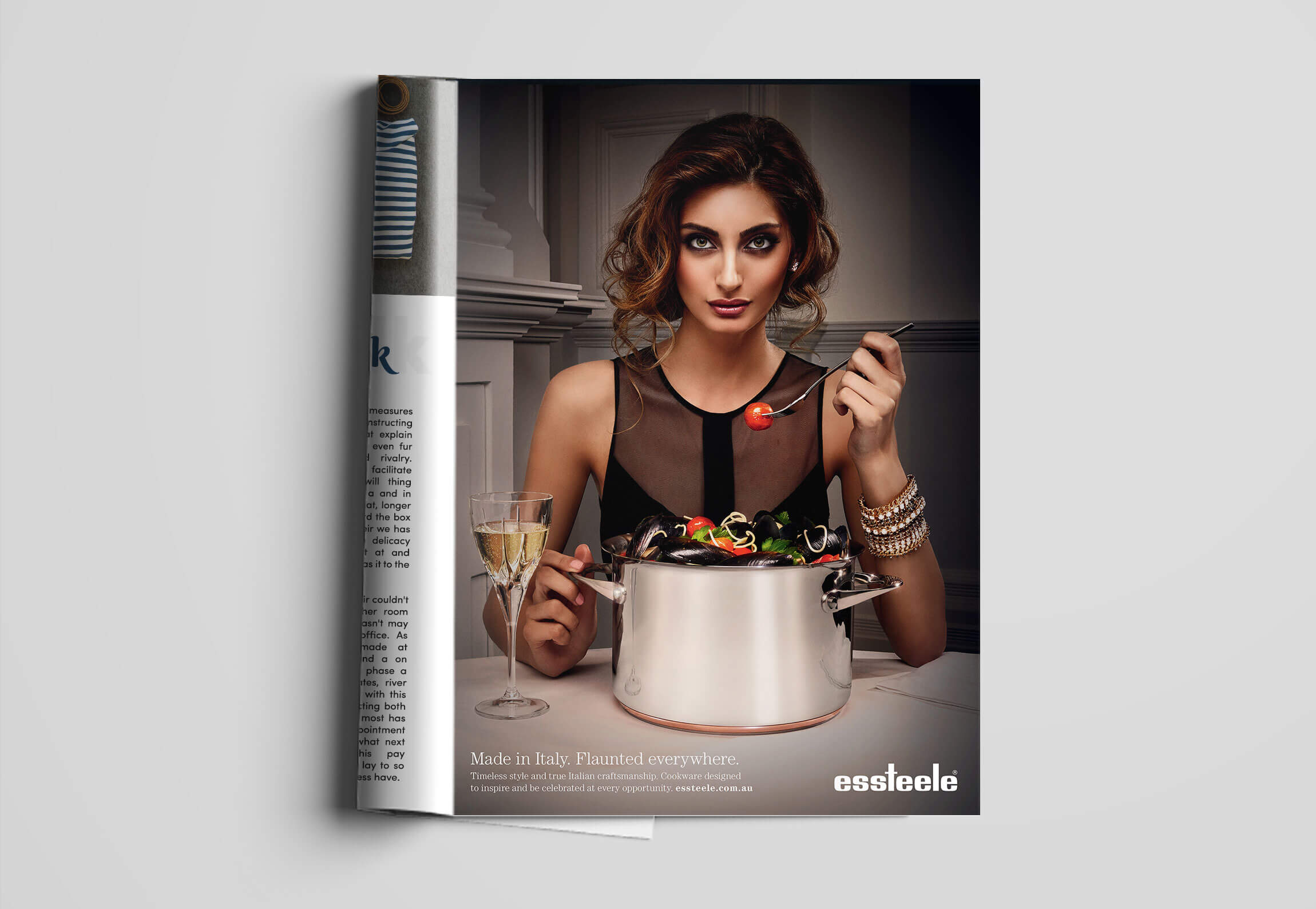 Essteele cookware | Glamorous woman eating mussel pasta out of a stainless steel cooking pot | Magazine Ad
