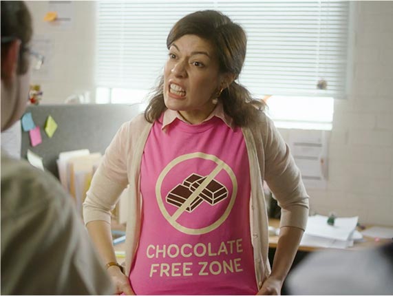 Choctober TVC | Frustrated woman wearing Chocolate Free Zone pink t-shirt