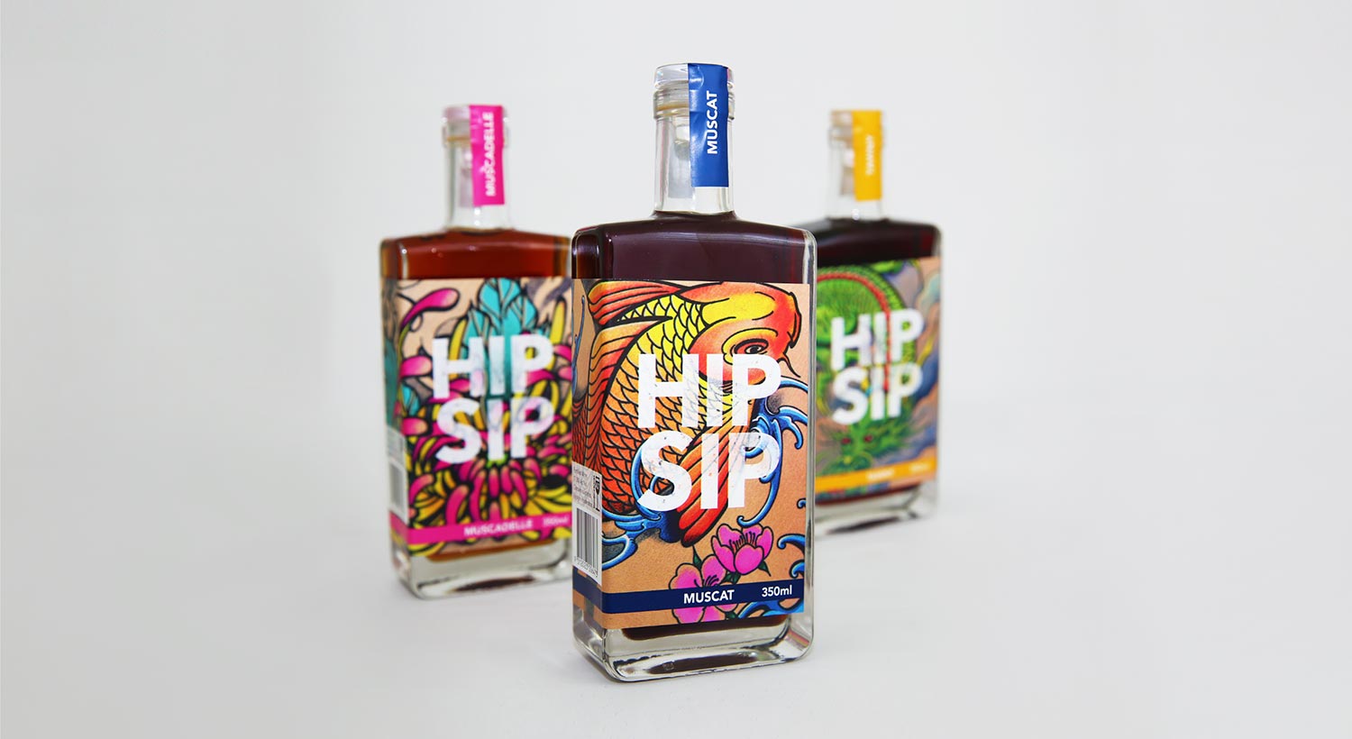 Trio of Hip Sip bottles with tattoo artwork on grey background