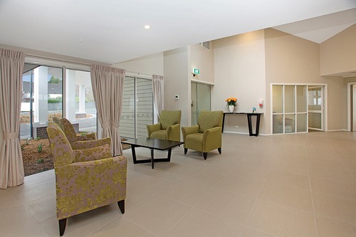 Lounge Aged Care Accent Chair in green fabric at reception