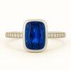 Brilliyond Jewellery white gold ring with rectangular blue sapphire center and diamond accents, Celestia Blue.