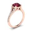 A natural 6mm round cut garnet handset over an 18k rose gold engagement ring.