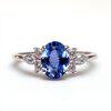 blue sapphire multi stone engagement ring with prominent centre stone