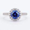 blue sapphire halo engagement ring with prominent accent stones