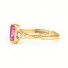 Brilliyond Jewellery’s octagon step cut pink sapphire ring with side diamonds in 18K yellow gold, The Rosella.
