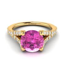 A natural pink Ceylon sapphire centre stone with 26 white created diamond accent stones.